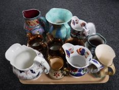 A tray of late 19th and 20th century jugs examples of Imari, copper lustre,