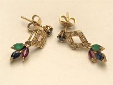 A pair of multi-gemstone earrings, each with a marquise-cut emerald,
