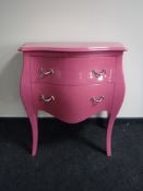 A pink two drawer commode chest