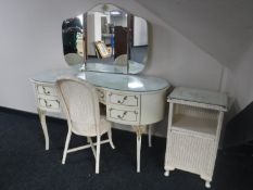A cream and gilt kidney shaped dressing table,