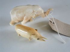 Two Japanese ivory figures of an elephant and a rhinoceros