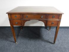 A Regency style writing desk with inset green leather panel