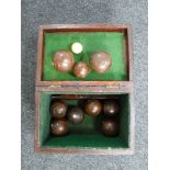 An early 20th century wooden box containing French wooden boules