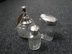 Two sterling silver lidded jars and a sterling silver rimmed perfume bottle
