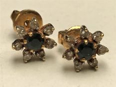 A pair of diamond and sapphire cluster earrings