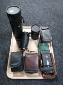 A tray of four cameras including Helina, Kodak, camera lenses,