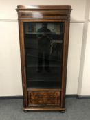 A continental walnut and ebonised display cabinet,