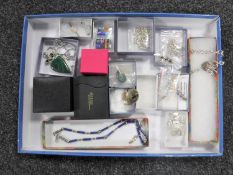 A tray of assorted silver and costume jewellery - necklaces, brooches,