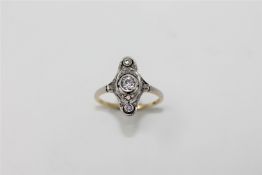 An Art Deco style diamond ring, a column of three old cut diamonds upon a pierced,