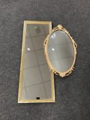 An oval gilt framed mirror and a gilt framed hall mirror