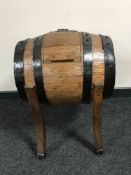 An oak coopered barrel on stand