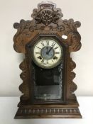 An American Ansonia mantel clock in carved case