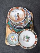 A tray of eleven 20th century oriental wall plates and bowls