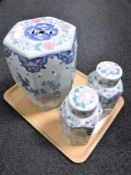 An Oriental style floral glazed porcelain stool and pair of lidded ginger jars
