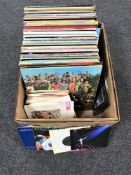 A box of LP's and 45's including The Beatles, Rolling Stones, Fleetwood Mac,