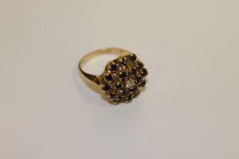 An 18ct gold sapphire and diamond cluster ring, 7.