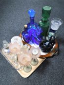 A tray of twin handled serving tray, assorted glass decanters, glass candle holders,