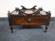 An early Victorian rosewood Canterbury base raised on castors