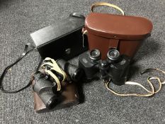 Three sets of cased binoculars,