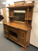 A late Victorian oak breakfronted mirror backed sideboard,