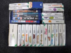A box of Nintendo DS games and five Blu Ray discs