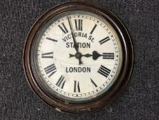 An early 20th century circular wall timepiece signed Victoria St.