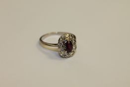 A 14ct white gold ruby and diamond cluster ring,