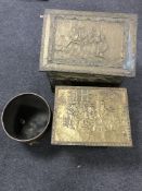 Two brass embossed coal boxes and a copper coal bucket on paw feet