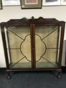 A 20th century mahogany display cabinet on claw and ball feet