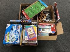 Four boxes of assorted board games, jigsaws, Scalectrix track,