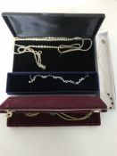 A boxed Swarovski bracelet together with three costume necklaces