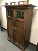 An early twentieth century Continental carved oak two door cabinet,