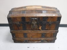 An antique iron bound domed shipping trunk