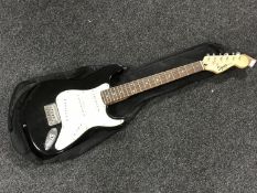 A Squier by Fender mini electric guitar in carry bag