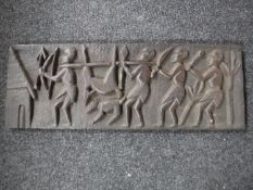 A carved hardwood panel depicting tribal huntsmen