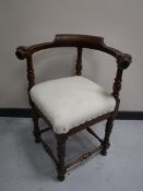 A nineteenth century carved oak corner chair with lion mask arms,