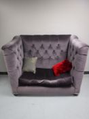 A contemporary high back settee, upholstered in a mauve button fabric,