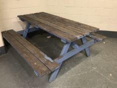 A fixed position wooden table and bench set,