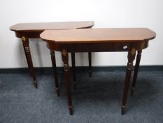 A pair of inlaid mahogany hall tables on reeded legs