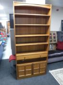 A set of late twentieth century teak Nathan bookshelves fitted a drawer