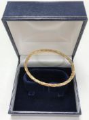 A 9ct gold bangle, 4.2g.