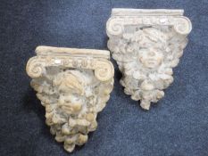 A pair of ornate plaster corbels
