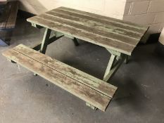 A fixed position wooden table and bench set,