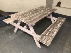 A fixed position wooden table and bench set,