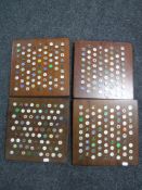 A large quantity of golfing studs mounted on four boards