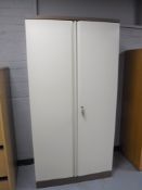 A metal double door stationary cabinet with key