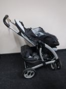 A Graco Quattro Tour Deluxe push chair with accessories