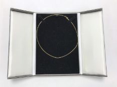 A 9ct gold fine line necklace, 3.9g.