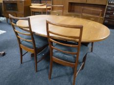 An oval 1970's teak G plan extending dining table, fitted a leaf,