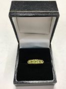A 9ct gold dress ring set with green stones, size N/O.